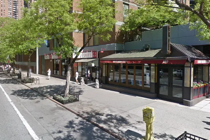 A Google Street view showing the sidewalk of 411 West 42nd Street, which is near the West Bank Cafe